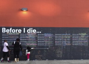 “Before I Die ____” Chalkboard in a parking lot off of Camp